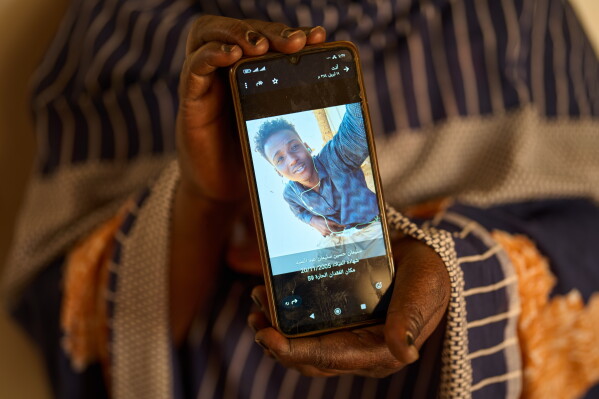 Sulafa Mustafa shows a photograph of her missing son, Suleiman Abdelsaid, in Omdurman, Sudan, Tuesday, April 21, 2026. (AP Photo/Bernat Armangue)