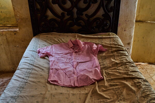 A shirt belonging to Suleiman Abdelsaid, who went missing in 2024 at age 18, is displayed on a bed at his family home in Omdurman, Sudan, Tuesday, April 21, 2026. (AP Photo/Bernat Armangue)