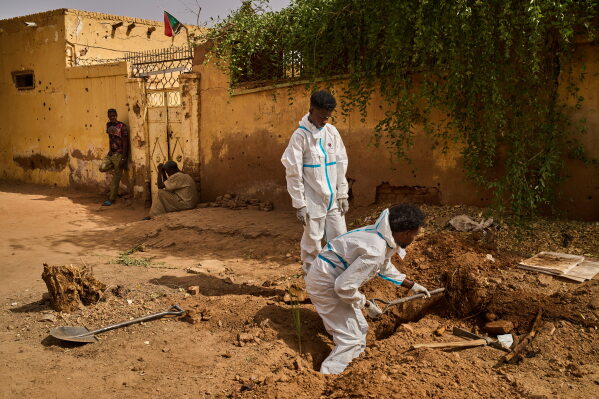 Staff from Sudan's Forensic Medicine Corporation exhume the body of Mohammed Alsawi, 73, who was killed in 2023 by the paramilitary Rapid Support Forces, or RSF, in Omdurman, Sudan, Monday, April 20, 2026. (AP Photo/Bernat Armangue)