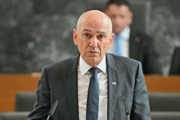 Janez Jansa addresses the Slovenian Parliament during a session in Ljubljana, Slovenia, Friday, May 22, 2026, before appointing him as prime minister, ending a political deadlock after tight elections in March. (AP Photo/Igor Kupljenik)