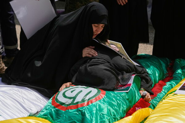 Women grieve over the bodies of relatives who were killed on Tuesday in Israeli airstrikes in the southern village of Deir Qanoun al-Nahr, ahead of their funeral procession inside a morgue in the southern port city of Tyre, Lebanon, Thursday, May 21, 2026. (AP Photo/Mohammed Zaatari)