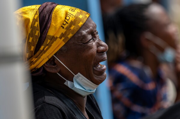 A woman mourns her child, who died of Ebola, at the General Hospital in Bunia, Congo, Thursday, May 21, 2026. (AP Photo/Moses Sawasawa)