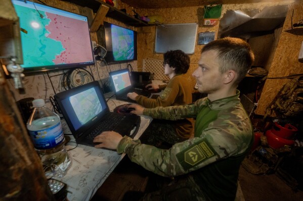 Ukrainian servicemen of Khartia brigade check the drone aerial view in the command centre Kharkiv region, Ukraine, Wednesday, May 20, 2026. (AP Photo/Andrii Marienko)